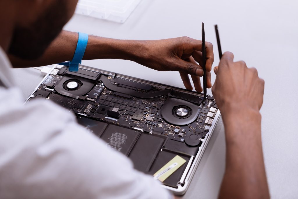 technician repairing a macbook